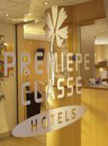 a sign for a kitchen with a flower on a counter at Premiere Classe Cergy Saint Christophe in Cergy