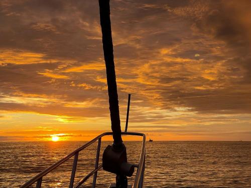 a view of the sunset from the bow of a boat at Paradiselodge Jungleguesthouse in Platanillo