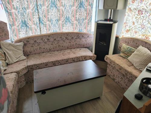 a living room with a couch and a table at Le Petit Logis in Philippeville
