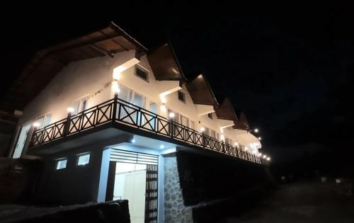 a building with a balcony on top of it at night at Harika Palace in Nainital