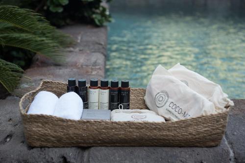 a basket with towels and other items next to the water at Hiraeth Santorini in Megalokhori