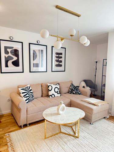 a living room with a couch and a table at Cozy Flat near Airport & Sarajevo Center, Free Parking in Sarajevo