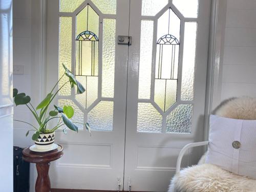 a front door with a potted plant in a chair at Studio 59 Newport sleeps1 in Newport