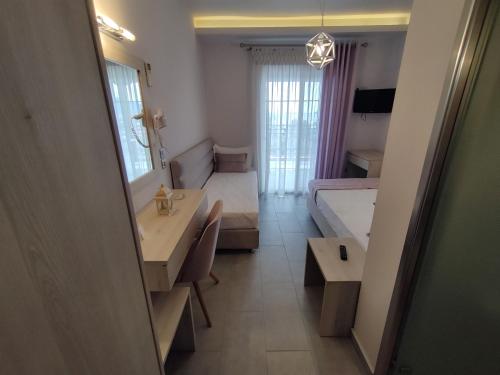 a small room with a bedroom and a bed at Studios Apollon in Chrysi Ammoudia