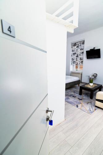 a white door in a living room with a couch at Old Town Whisper Apartments in Sarajevo