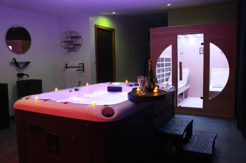 a large bathroom with a large tub with lights in it at Nuit Blanche Normandie in Eu