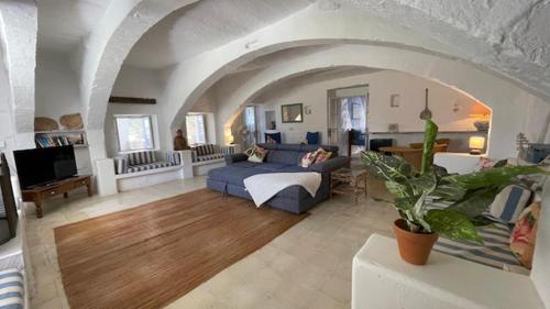 a living room with a blue couch in a living room at Casa Palma Gozo in Għarb