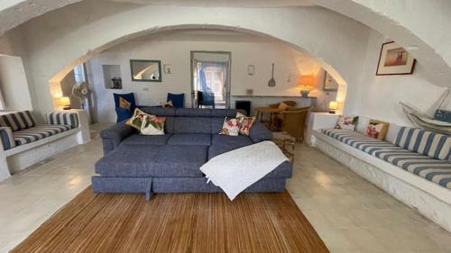 a large living room with a blue couch and chairs at Casa Palma Gozo in Għarb