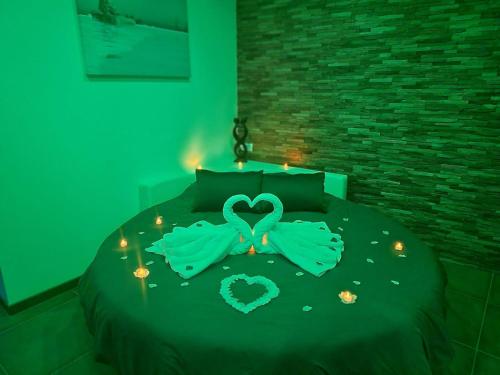 a bedroom with a bed with a heart made out of lights at Nuit Blanche Normandie in Eu