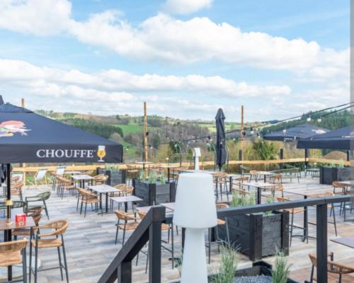 a patio at a restaurant with tables and chairs at Maison Aunais in Mormont-La-Grande
