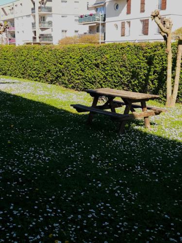 a wooden picnic table sitting in the grass at Premiere Classe Strasbourg Ouest in Strasbourg