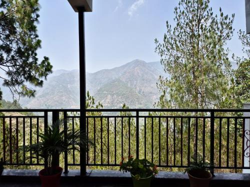 a balcony with a view of mountains at Hotel Lansdowne Vacations in Lansdowne