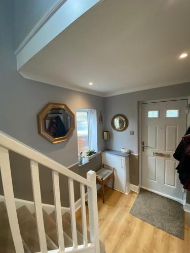a living room with a staircase and a stair case at Ely Cathedral family home in Ely