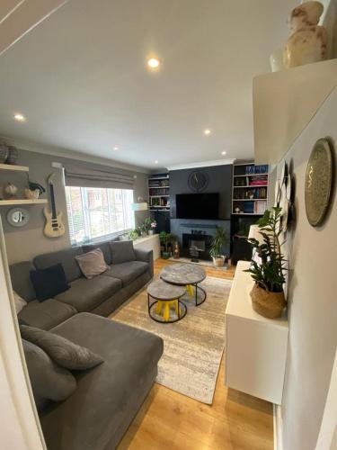 a living room with a couch and a table at Ely Cathedral family home in Ely