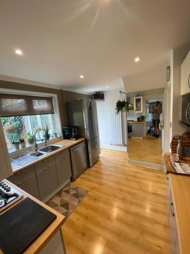 a kitchen with wooden floors and stainless steel appliances at Ely Cathedral family home in Ely