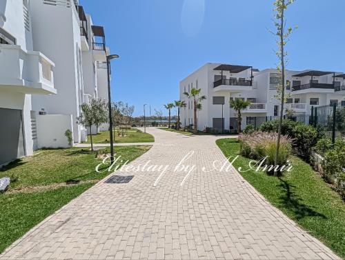 a walkway in front of some apartment buildings at EliteStay by Al Amir in Cabo Negro