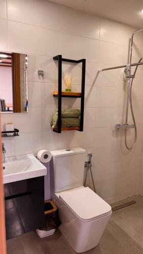 a bathroom with a toilet and a sink and a shower at Todor Resort in Arjut