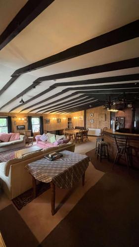 a large living room with couches and tables in it at Scorrabrae Orphir Mainland Orkney South Shore Retreat in Orphir