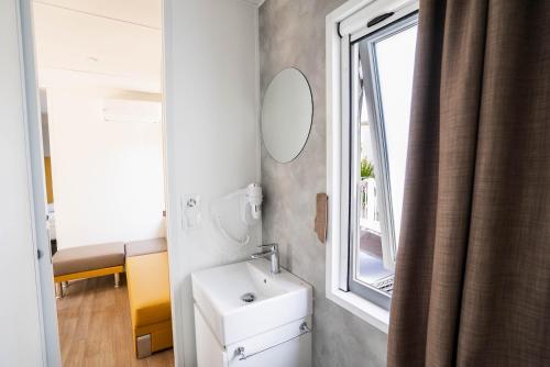 a bathroom with a sink and a window at Camping Fossalta in Lazise