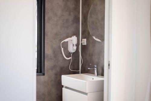 a bathroom with a sink and a mirror at Camping Fossalta in Lazise