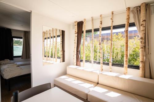a living room with a couch and a window at Camping Fossalta in Lazise