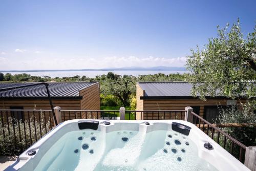 a hot tub on the deck of a house at Camping Fossalta in Lazise