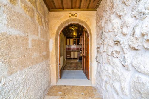 a hallway of a house with a stone wall at Asyada Suites Hotel in Nevsehir