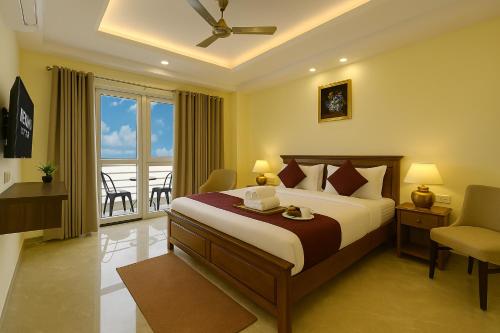 a hotel room with a bed and a balcony at Nexhub Luxe57 1BHK- Golf Course Road in Gurgaon