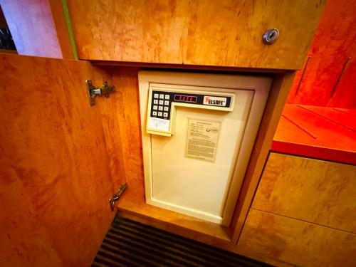an atm machine in a wooden cabinet in a room at Hotelzimmer mit einer Kitchenette - nähe Frankfurt-Messe - fair in Frankfurt/Main