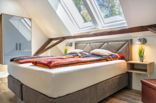 a bedroom with a large bed with skylights at Ahrenshof 7 in Bad Zwischenahn