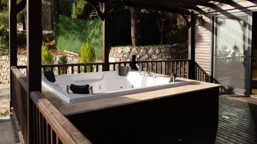 a bath tub sitting on a deck in a house at Sapolto Villas Faralya in Fethiye