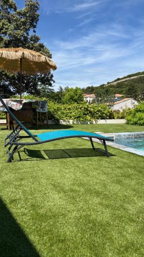 a slide in the grass next to a swimming pool at Chambre indépendante avec salle de bain in Saint-Paul-et-Valmalle