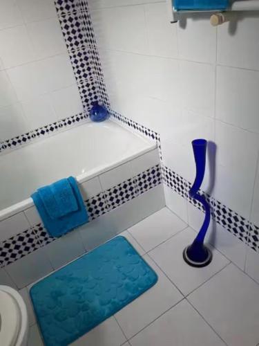 a bathroom with a bath tub with a blue vase at 1-Bed Apt 10 mins to Beach Choose from 4 Pools in San Miguel de Salinas