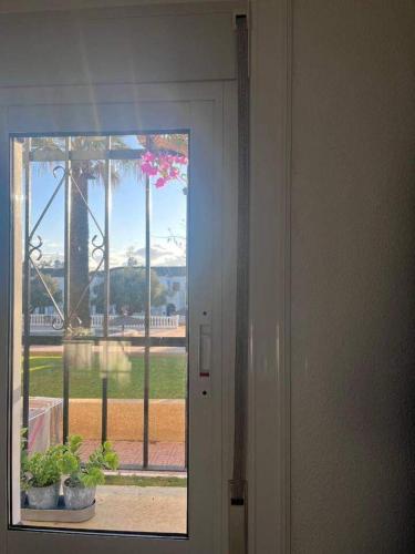a door leading to a window with a view of a park at 1-Bed Apt 10 mins to Beach Choose from 4 Pools in San Miguel de Salinas