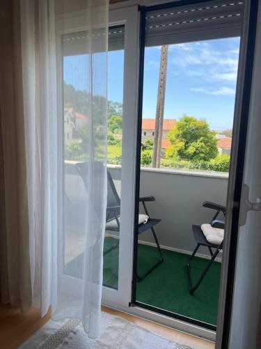 a room with a sliding glass door with a view at Grace House in Belinho