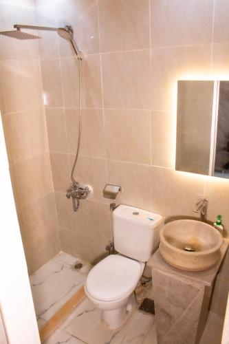 a bathroom with a toilet and a sink at Pyramids sun set view in Cairo