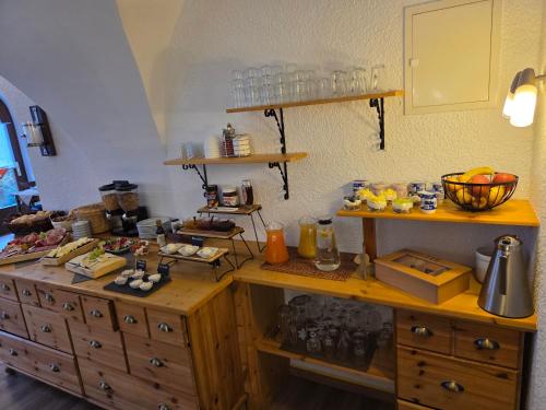 a kitchen with a counter with food on it at Pension Gisela in Gößweinstein