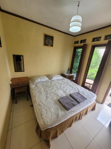 a bedroom with a large bed in a room at Ayem Tentrem Homestay in Selo