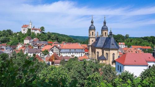 a view of a town with buildings and a castle at Pension Gisela in Gößweinstein
