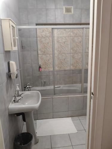 a bathroom with a sink and a bath tub at La Rochelle Inn in Richards Bay