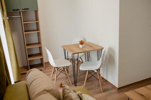 a living room with a table and white chairs at Villa Petra in Ohrid