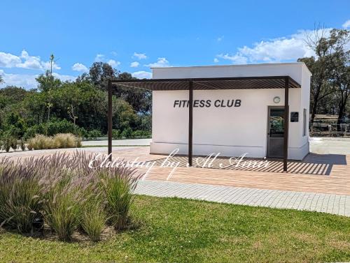 a white building with a fitness club sign on it at EliteStay by Al Amir in Cabo Negro