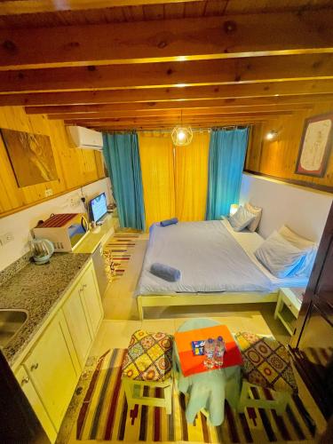 a small room with a bed and a table in it at Skyrock Dahab in Dahab