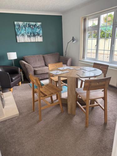 a living room with a table and chairs and a couch at Primley View in Goodrington