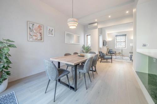 a dining room and living room with a table and chairs at Luxurious 4 bedroom home in Kensington in London
