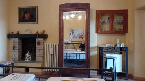 a living room with a mirror and a fireplace at affittacamere La Betulla in Pettinengo