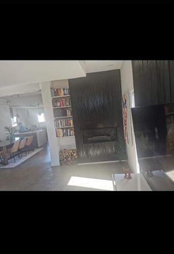 a living room with a fire place in a living room at Mkhuhla Rentals in Roodepoort