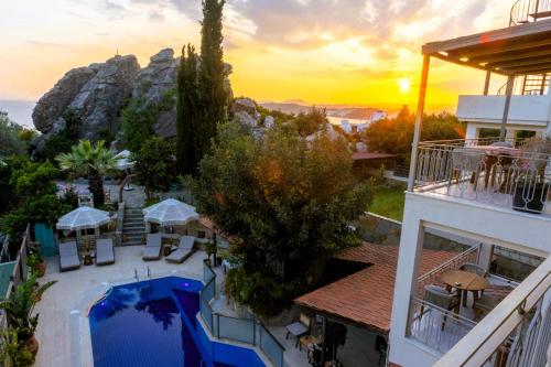 a hotel with a view of the ocean at sunset at The Aegean Gate Hotel in Bodrum City