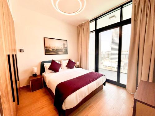 a bedroom with a bed and a large window at 1 Bedroom 1 Min walking to Cleveland and Galleria Mall by Central Stay in Abu Dhabi