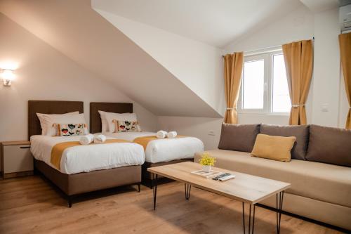 a living room with two beds and a couch at Villa Petra in Ohrid